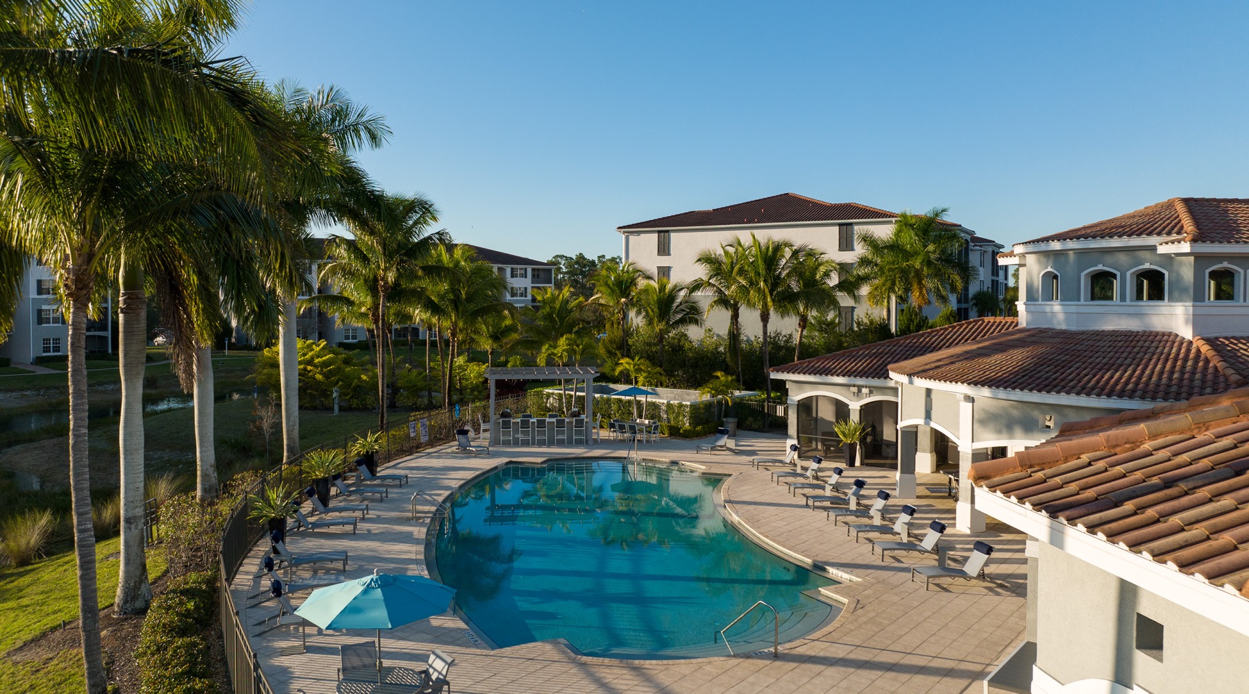 Resort-style swimming pool with lounge seating